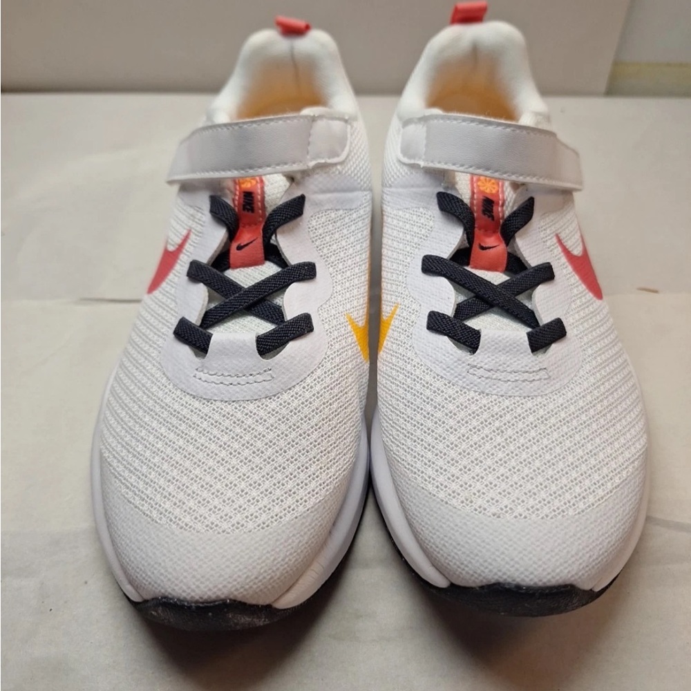 Nike Kids White Sneakers with Coral Swoosh and Yellow Accent